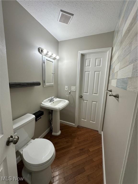 5330 Willow Ln, Sheffield Lake, OH 44054 - half bath featuring wood finished floors and a textured ceiling
