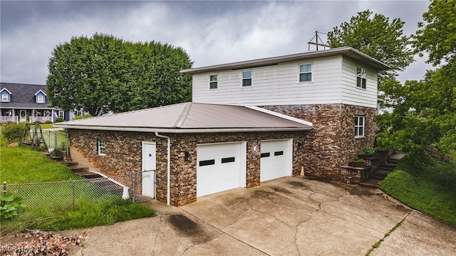 2691 State Route 339, Belpre, OH 45714 - view of property exterior with concrete driveway, brick siding, stone siding, and an attached garage