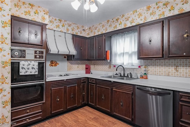 2691 State Route 339, Belpre, OH 45714 - kitchen with stainless steel dishwasher, extractor fan, wallpapered walls, white electric stovetop, and light countertops