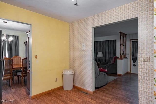 2691 State Route 339, Belpre, OH 45714 - hall with wood finished floors, a chandelier, and wallpapered walls