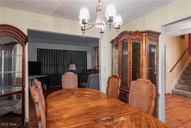 2691 State Route 339, Belpre, OH 45714 - dining space featuring wood finished floors, a chandelier, and stairway
