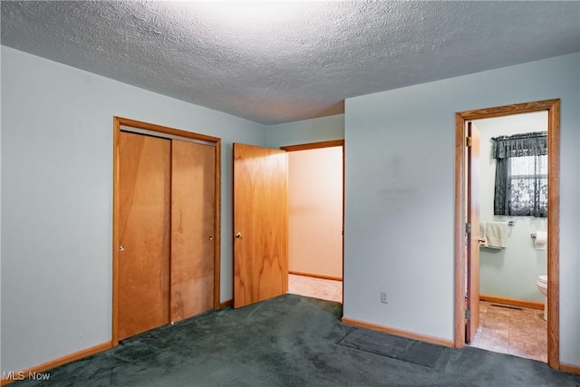 2691 State Route 339, Belpre, OH 45714 - unfurnished bedroom featuring a closet, carpet flooring, a textured ceiling, and ensuite bath