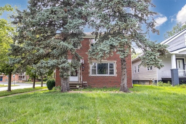 426 E 200th St, Euclid, OH 44119 - back of house featuring a lawn and brick siding