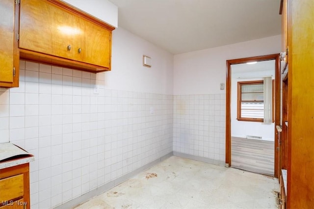 426 E 200th St, Euclid, OH 44119 - bathroom with tile walls, tile patterned floors, vanity, and wainscoting