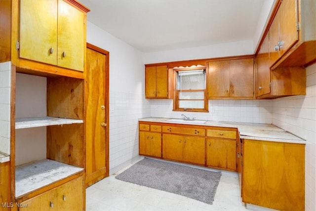 426 E 200th St, Euclid, OH 44119 - kitchen with light countertops, light flooring, brown cabinetry, and decorative backsplash