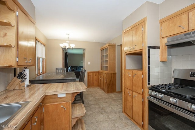 505 Lansing Rd, Akron, OH 44312 - kitchen with stainless steel gas range oven, under cabinet range hood, a chandelier, open shelves, and decorative backsplash