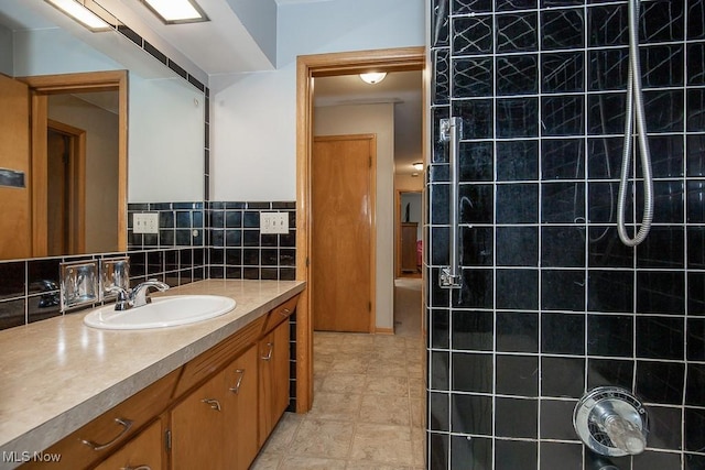 505 Lansing Rd, Akron, OH 44312 - bathroom featuring vanity, a tile shower, tile patterned flooring, and backsplash