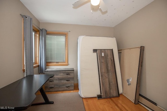 505 Lansing Rd, Akron, OH 44312 - bedroom featuring wood finished floors, a baseboard radiator, and ceiling fan
