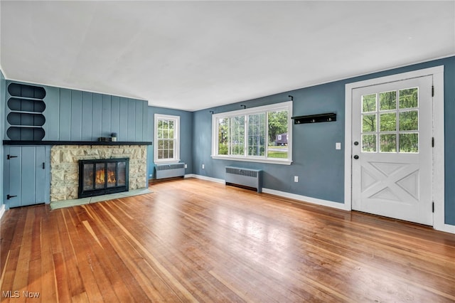 8743 Usher Rd, Olmsted Twp, OH 44138 - unfurnished living room with radiator, wood-type flooring, and healthy amount of natural light