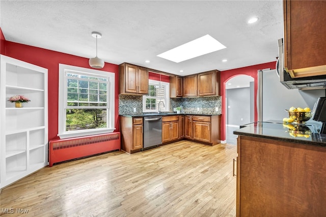 8743 Usher Rd, Olmsted Twp, OH 44138 - kitchen with appliances with stainless steel finishes, a skylight, radiator, light wood-style flooring, and recessed lighting