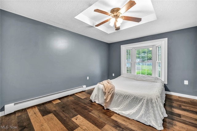 8743 Usher Rd, Olmsted Twp, OH 44138 - bedroom with a baseboard heating unit, wood finished floors, ceiling fan, a raised ceiling, and a textured ceiling