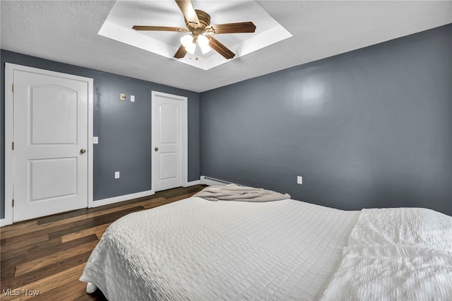 8743 Usher Rd, Olmsted Twp, OH 44138 - bedroom with a skylight, wood finished floors, a baseboard heating unit, a ceiling fan, and a textured ceiling