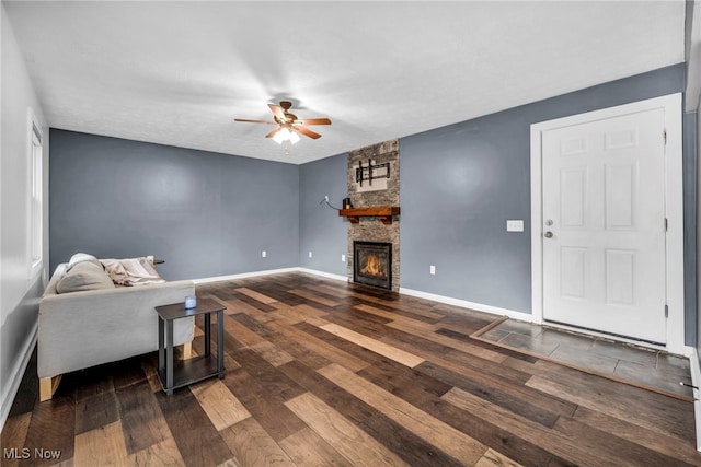 8743 Usher Rd, Olmsted Twp, OH 44138 - living area with wood finished floors, ceiling fan, and a stone fireplace