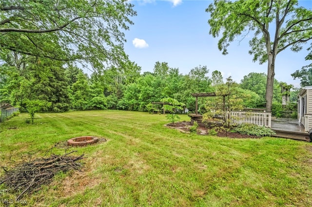 8743 Usher Rd, Olmsted Twp, OH 44138 - view of grassy yard featuring a fire pit and a deck