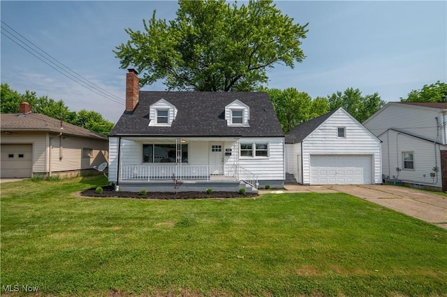 595 Elm St, Struthers, OH 44471 - cape cod home featuring covered porch, a front yard, a garage, and an outdoor structure