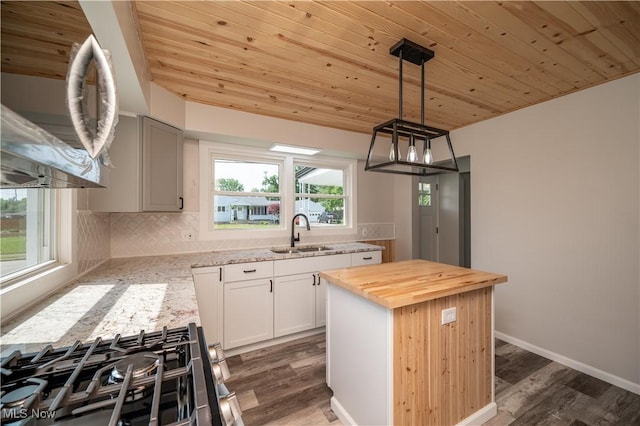 595 Elm St, Struthers, OH 44471 - kitchen featuring wooden counters, wood ceiling, dark wood-type flooring, tasteful backsplash, and a kitchen island