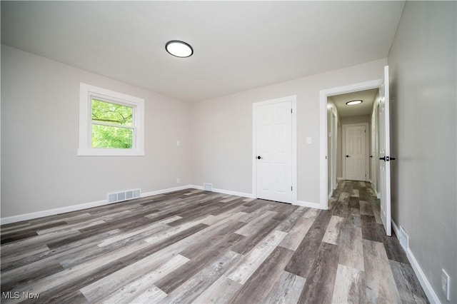 595 Elm St, Struthers, OH 44471 - unfurnished bedroom featuring wood finished floors and baseboards