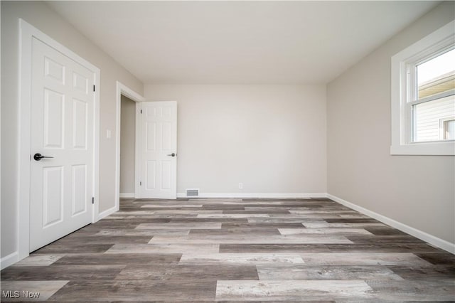 595 Elm St, Struthers, OH 44471 - unfurnished bedroom with baseboards and wood finished floors