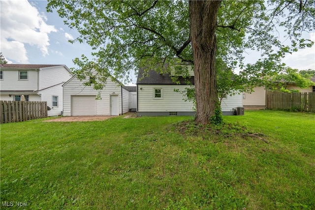 595 Elm St, Struthers, OH 44471 - rear view of house featuring a garage, driveway, and an outbuilding