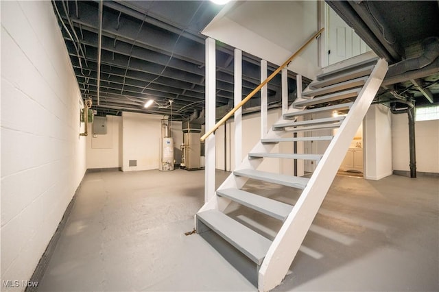 595 Elm St, Struthers, OH 44471 - finished below grade area featuring gas water heater, stairs, heating unit, electric panel, and concrete block wall