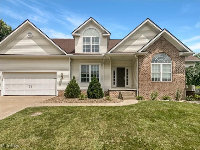 3217 Deborah Ct, Uniontown, OH 44685 - view of front of property featuring an attached garage, concrete driveway, a front yard, brick siding, and roof with shingles