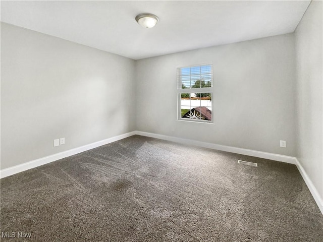 3217 Deborah Ct, Uniontown, OH 44685 - spare room featuring baseboards and dark colored carpet