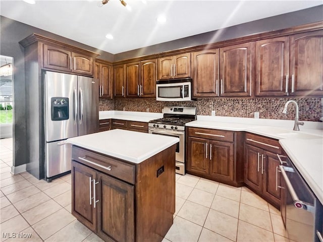 3217 Deborah Ct, Uniontown, OH 44685 - kitchen featuring stainless steel appliances, light tile patterned floors, backsplash, a center island, and recessed lighting