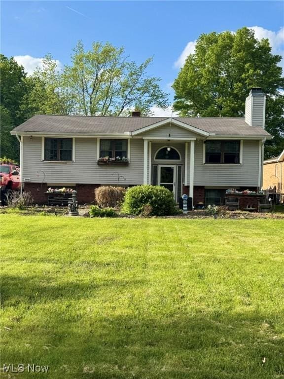 20684 Albion Rd, Strongsville, OH 44149 - view of front of home featuring a chimney and a front yard