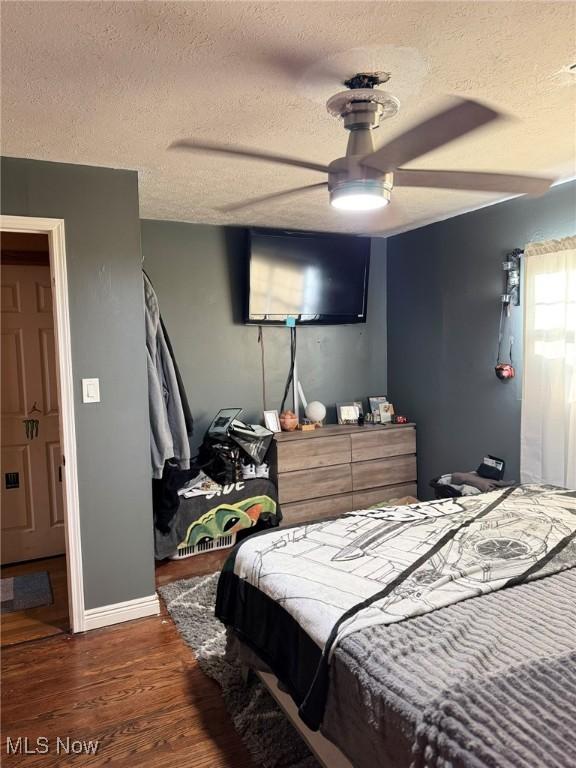 20684 Albion Rd, Strongsville, OH 44149 - bedroom featuring a textured ceiling, wood finished floors, and ceiling fan