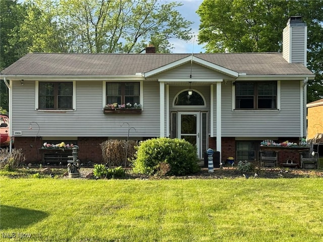 20684 Albion Rd, Strongsville, OH 44149 - split foyer home with a chimney, a front lawn, and brick siding