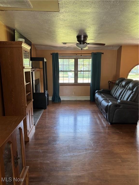 20684 Albion Rd, Strongsville, OH 44149 - living area featuring a textured ceiling, ceiling fan, and dark wood-type flooring