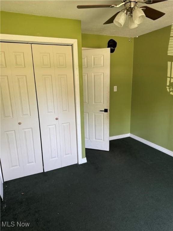 20684 Albion Rd, Strongsville, OH 44149 - unfurnished bedroom with dark colored carpet, a closet, and ceiling fan