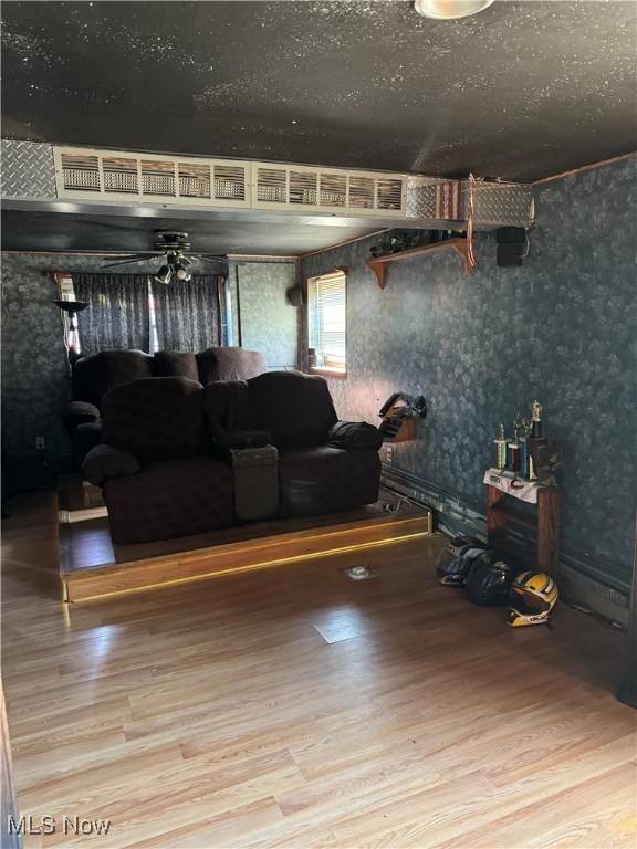 20684 Albion Rd, Strongsville, OH 44149 - living room with wood finished floors, wallpapered walls, and ceiling fan