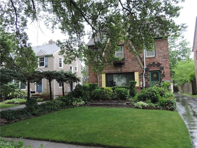 2323 Scholl Rd, University Heights, OH 44118 - view of front of property with brick siding and a front yard