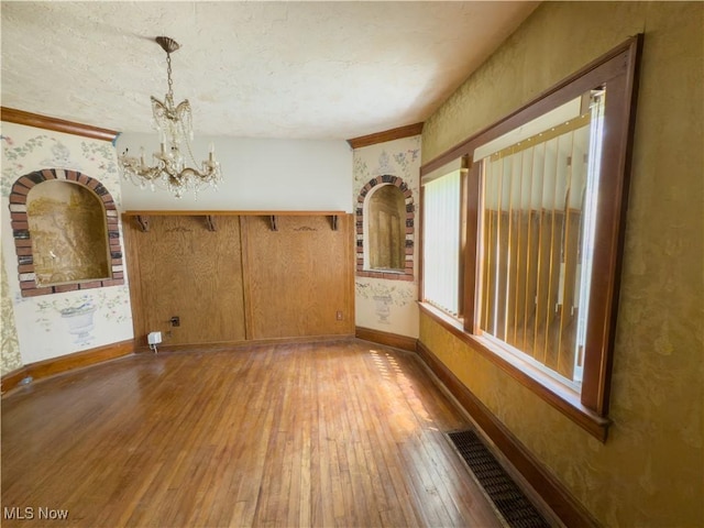 2323 Scholl Rd, University Heights, OH 44118 - empty room featuring hardwood / wood-style floors, a chandelier, and wallpapered walls