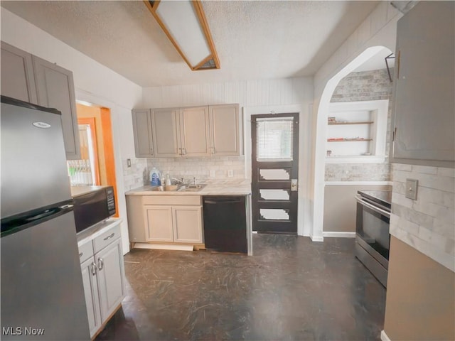 2323 Scholl Rd, University Heights, OH 44118 - kitchen with black appliances, light countertops, concrete flooring, backsplash, and a textured ceiling