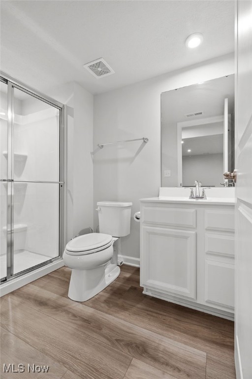 1809 Muirfield Ln, Painesville, OH 44077 - bathroom featuring vanity, wood finished floors, and a stall shower