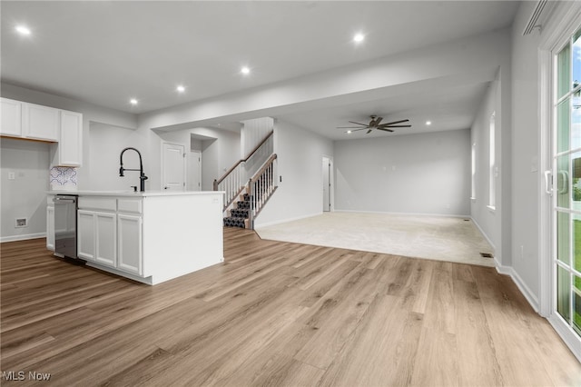 1809 Muirfield Ln, Painesville, OH 44077 - kitchen featuring stainless steel dishwasher, white cabinets, light wood finished floors, ceiling fan, and recessed lighting