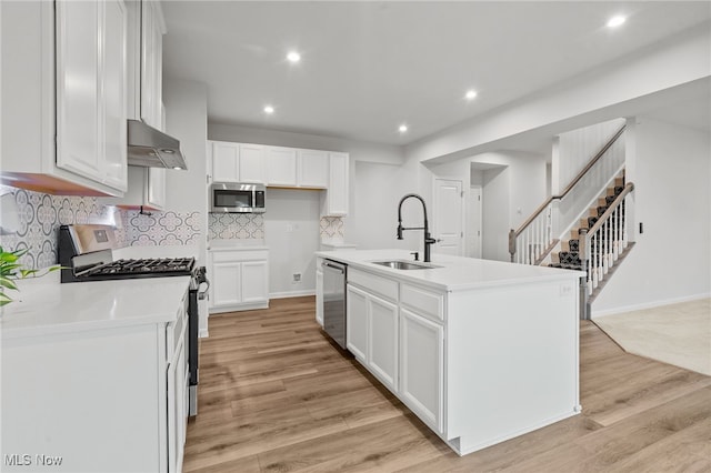 1809 Muirfield Ln, Painesville, OH 44077 - kitchen with stainless steel appliances, extractor fan, light wood-type flooring, white cabinetry, and recessed lighting