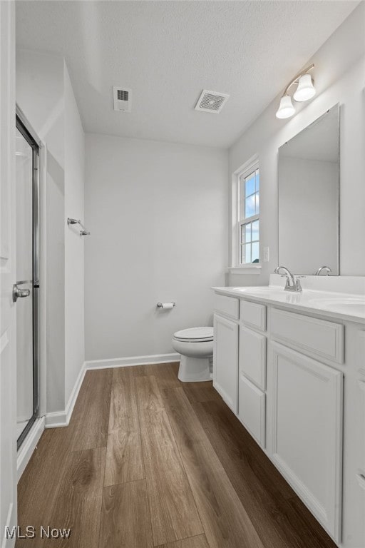 1809 Muirfield Ln, Painesville, OH 44077 - full bath featuring wood finished floors, an enclosed shower, vanity, and a textured ceiling