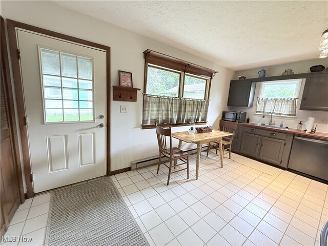 4901 Kings Creek Rd, Weirton, WV 26062 - kitchen with dishwasher, light tile patterned floors, a baseboard radiator, and a textured ceiling
