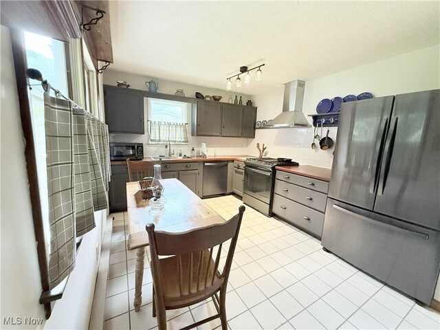 4901 Kings Creek Rd, Weirton, WV 26062 - kitchen featuring stainless steel appliances, ventilation hood, gray cabinetry, a textured ceiling, and light tile patterned flooring