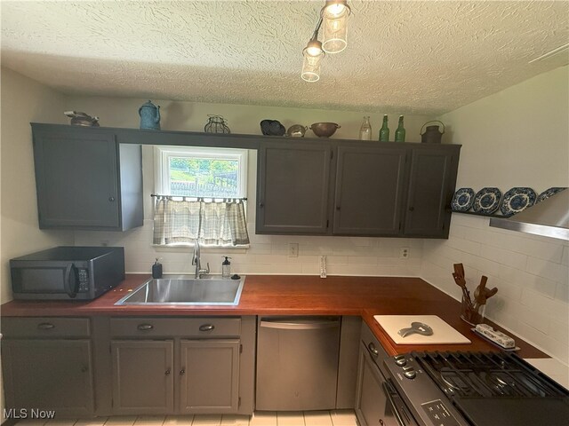 4901 Kings Creek Rd, Weirton, WV 26062 - kitchen featuring stainless steel dishwasher, gas stove, backsplash, a textured ceiling, and gray cabinetry