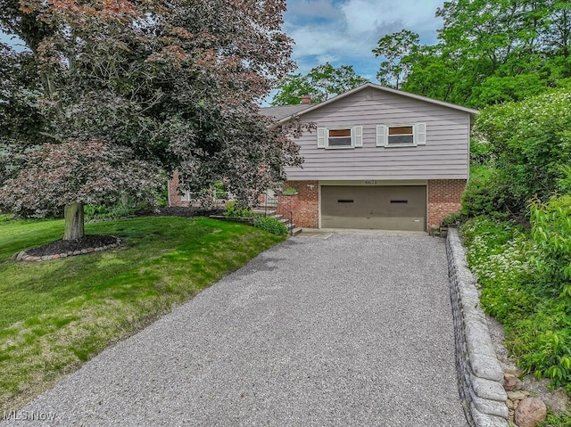 4671 Milford Dr, Perry, OH 44081 - tri-level home with brick siding, an attached garage, asphalt driveway, a front lawn, and a chimney