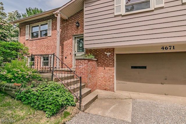 4671 Milford Dr, Perry, OH 44081 - view of exterior entry with a garage and brick siding
