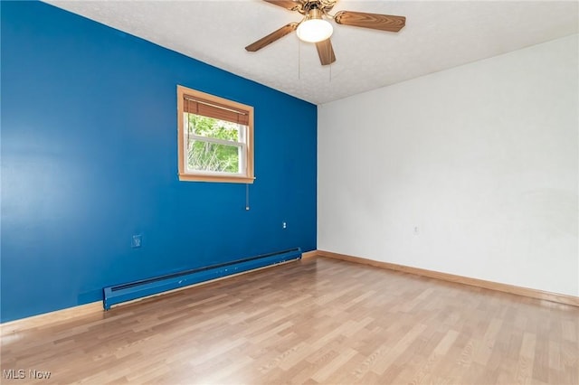 4671 Milford Dr, Perry, OH 44081 - empty room featuring a baseboard radiator, wood finished floors, and ceiling fan
