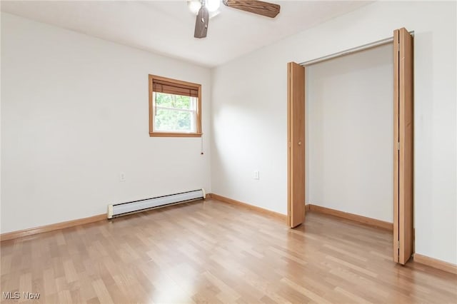 4671 Milford Dr, Perry, OH 44081 - unfurnished bedroom with a baseboard radiator, light wood-style flooring, and a ceiling fan