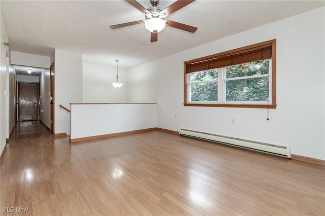 4671 Milford Dr, Perry, OH 44081 - unfurnished room featuring baseboard heating, light wood-type flooring, and ceiling fan