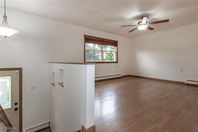 4671 Milford Dr, Perry, OH 44081 - spare room featuring a baseboard radiator, baseboard heating, ceiling fan, and wood finished floors
