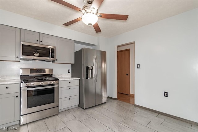 4671 Milford Dr, Perry, OH 44081 - kitchen featuring stainless steel appliances, gray cabinets, light countertops, and a ceiling fan